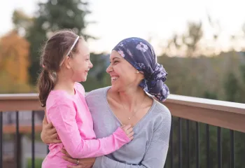 Mom who is a battling cancer holding her daughter