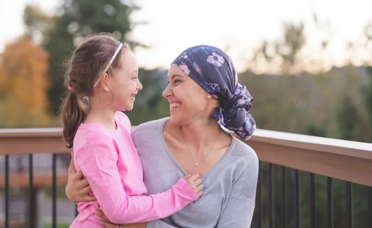 Mom who is a battling cancer holding her daughter