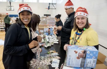women packing boxes at christmas